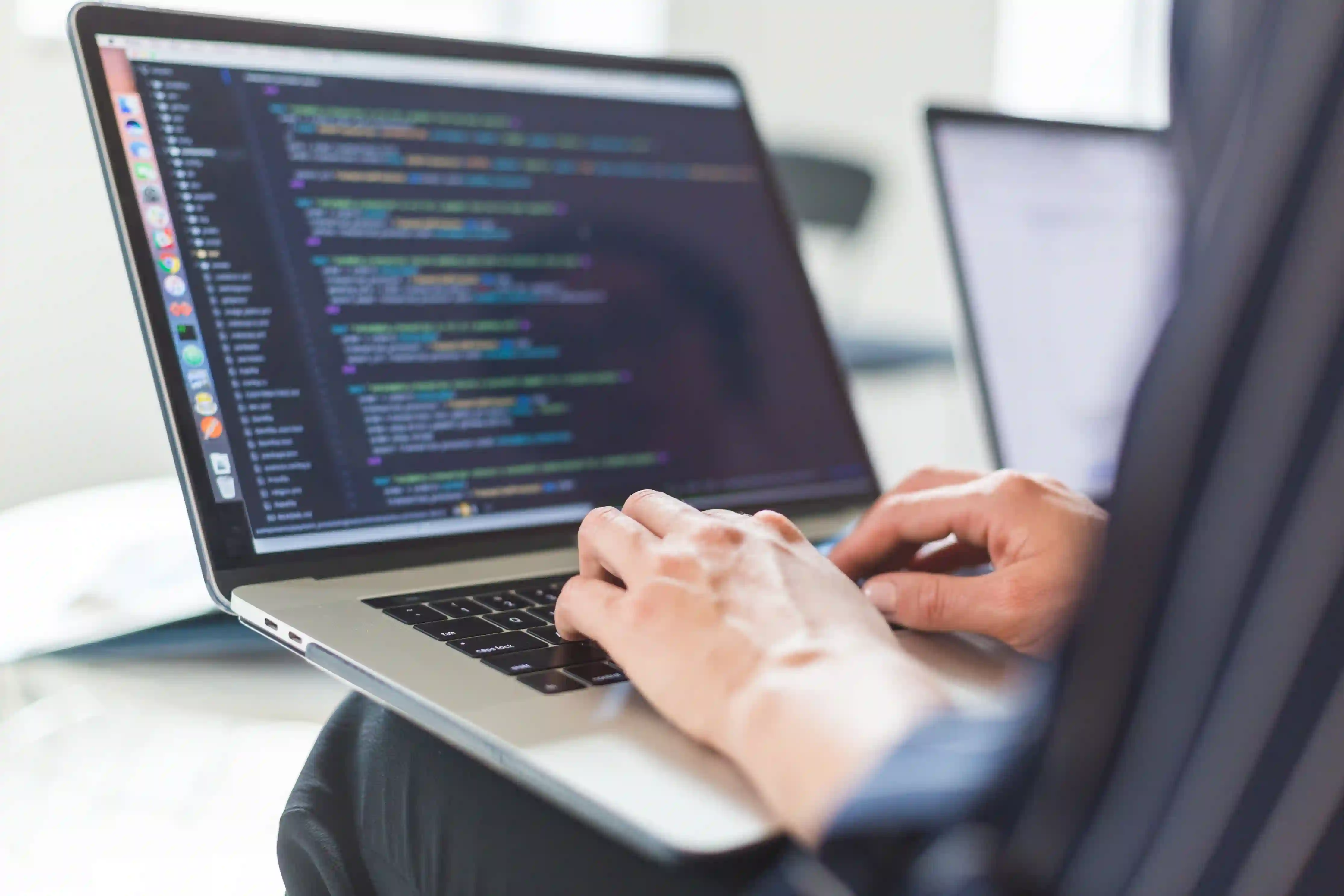 Developer coding on laptop